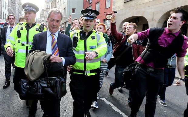 Farage escorted by police on a street in Edinburgh while adoring crowds point and shout at him, probably calling him a Nazi quizling discount Mosley cunt and telling him to fuck off out of Scotland forever or something similar.