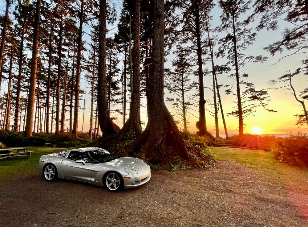 a 2007 Corvette in front of a Pacific Ocean sunset