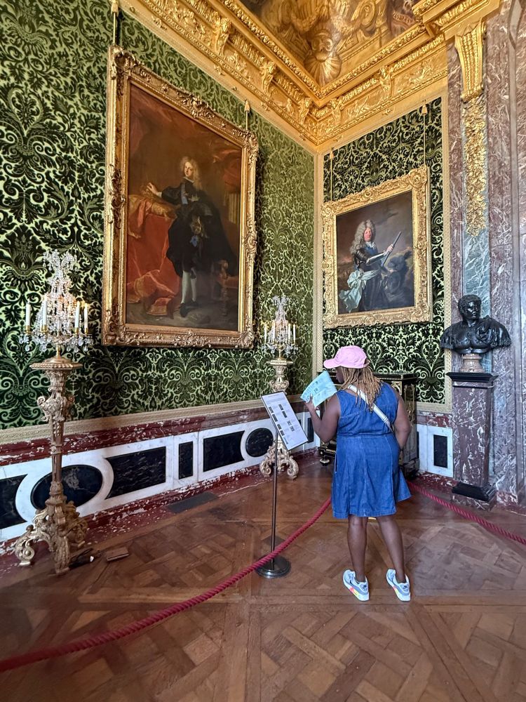 Me looking at big as portraits at Versailles. 