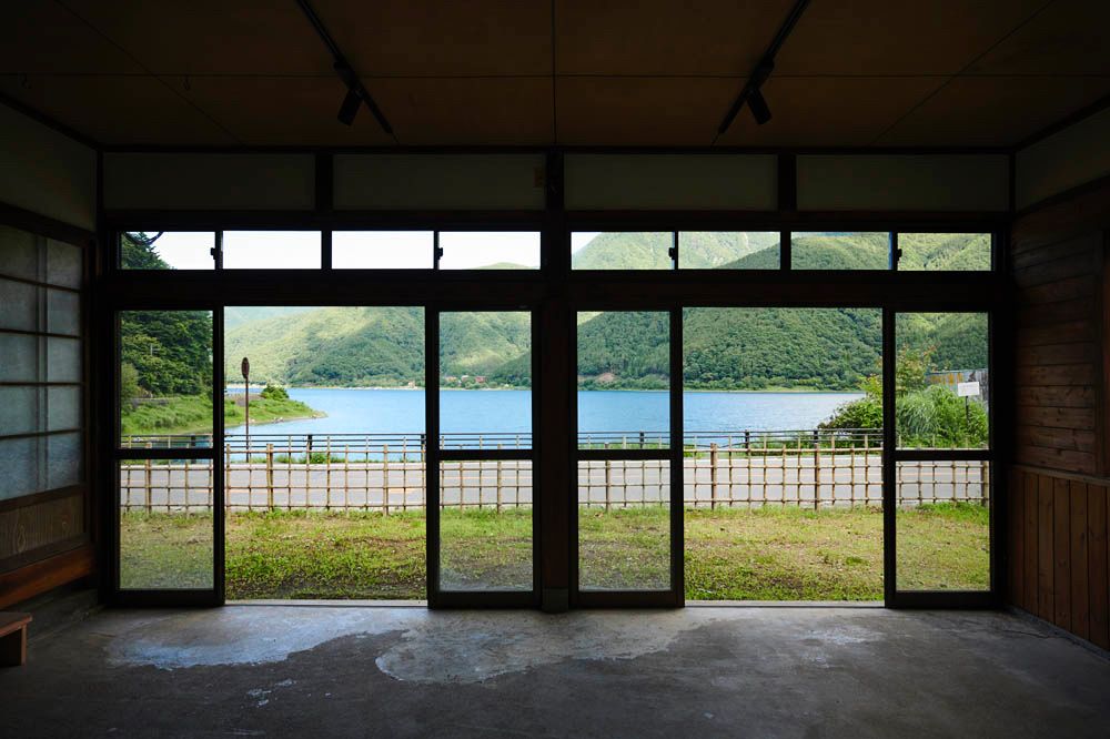 View out of a Japanese building onto Lake Saiko in the springtime.