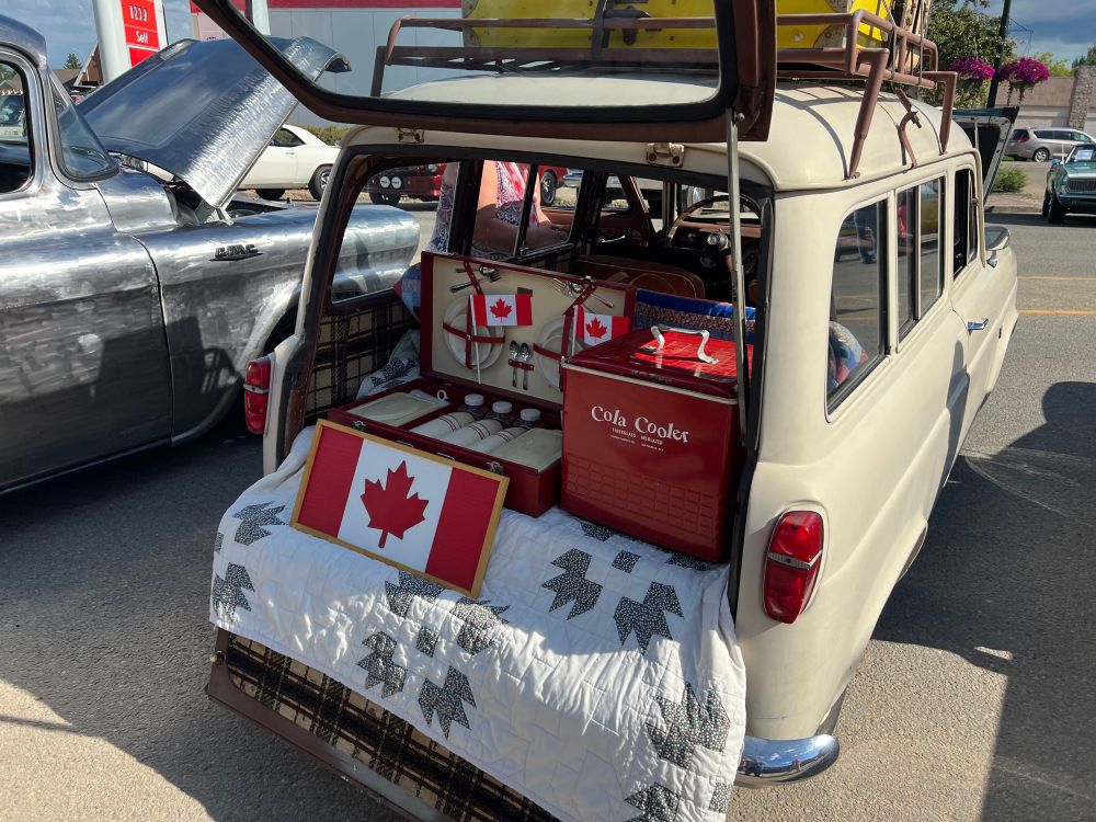 Back view of the Escort, with picnic supplies in the boot, including a handmade quilt