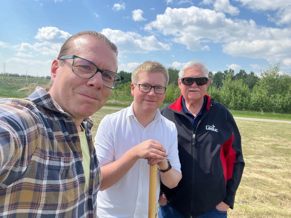 Councillors Ryan Pollard, Lars Hansen, and Glen Finstad standing in a field