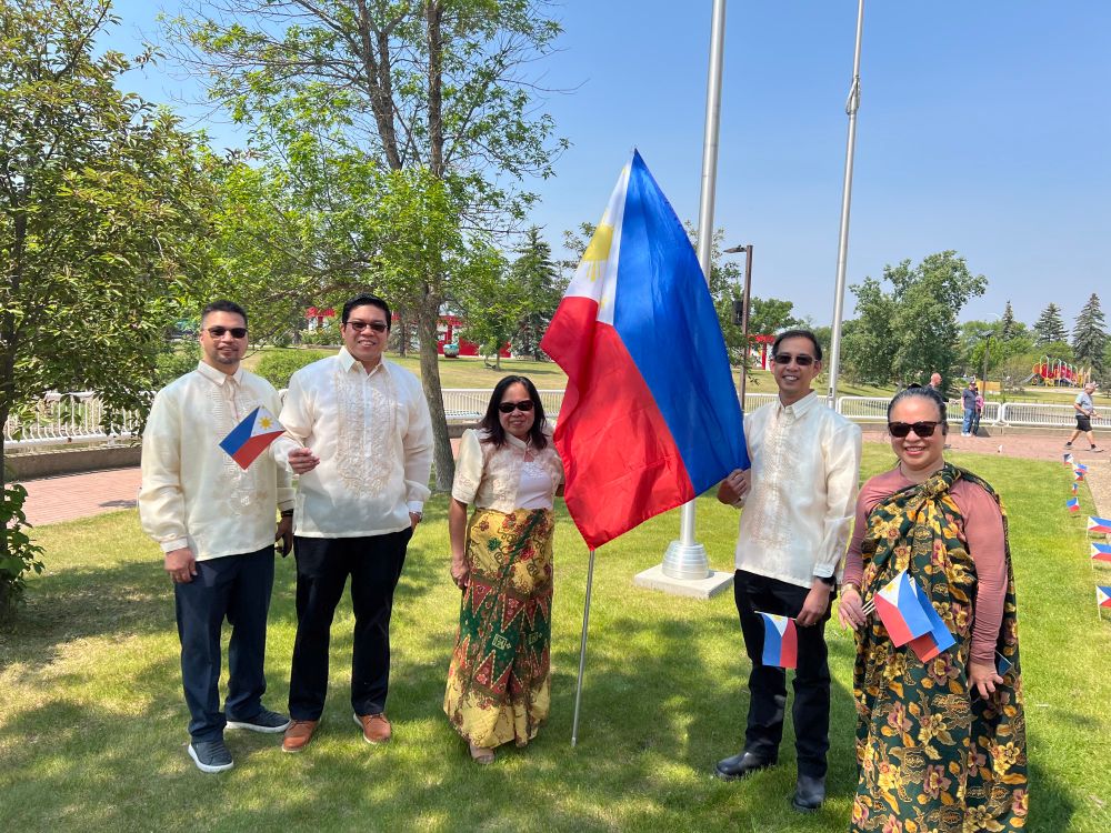 Members of the Filipino-Canadian Association of Leduc with Filipino flags and in traditional dress 