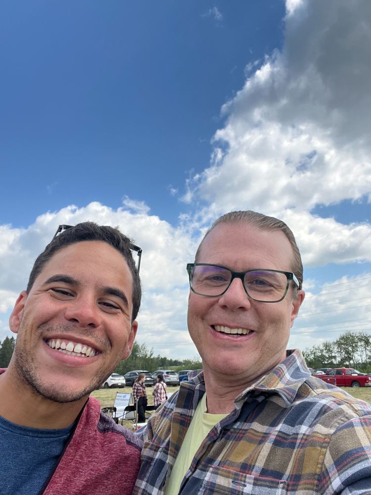 Councillor Ryan Pollard and Shawn Raymond standing in a field