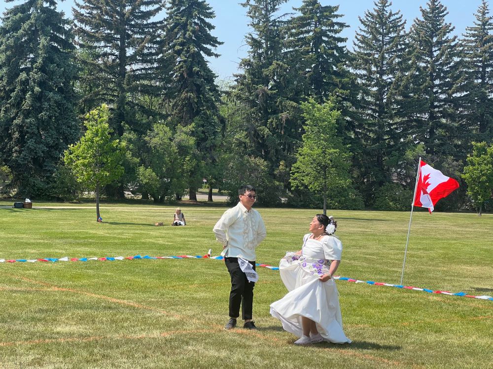 Two people doing at Filipino courtship dance 