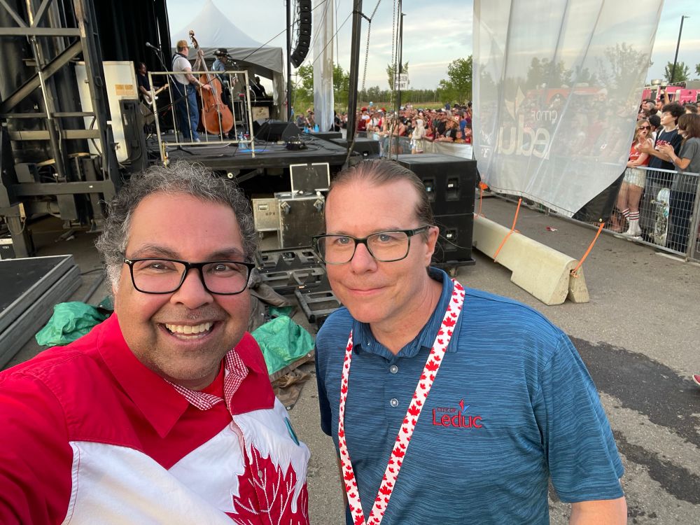 Naheed Nenshi and Ryan Pollard, with Corb Lund and the Hurtin’ Albertans in the background 