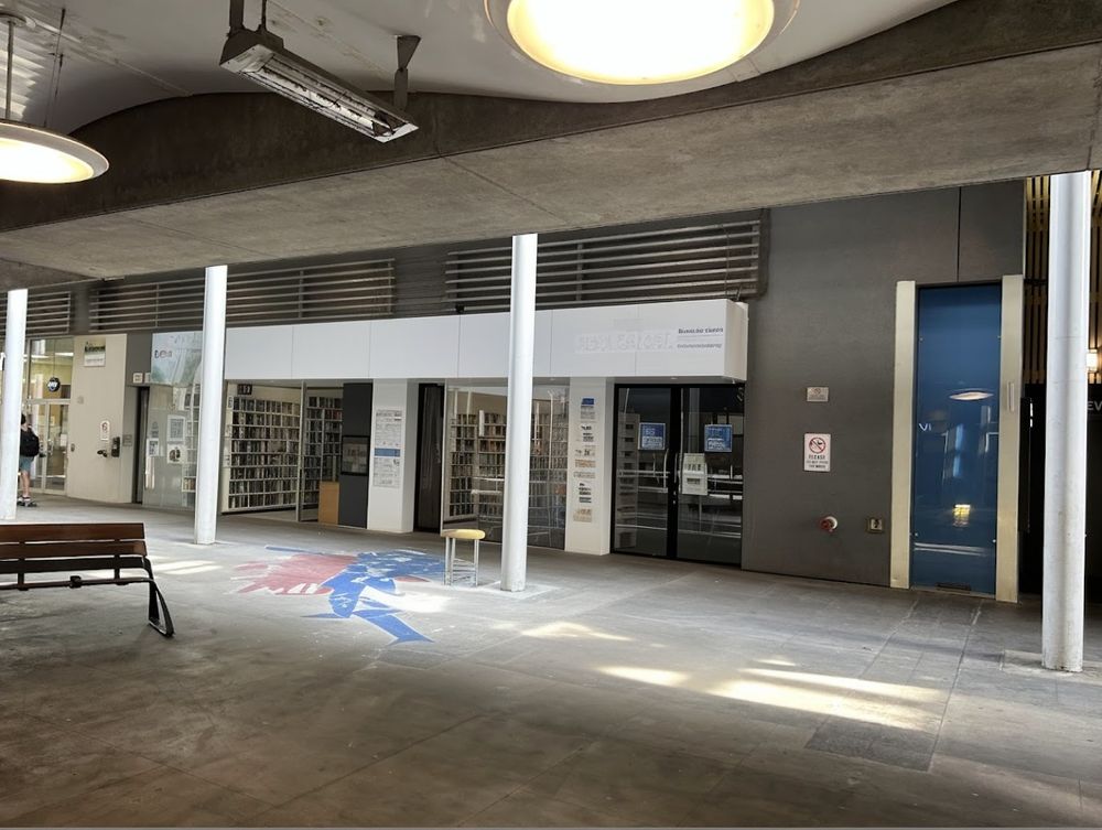 AI image of a vacant storefront in New Westminster station remodeled as a small library space.