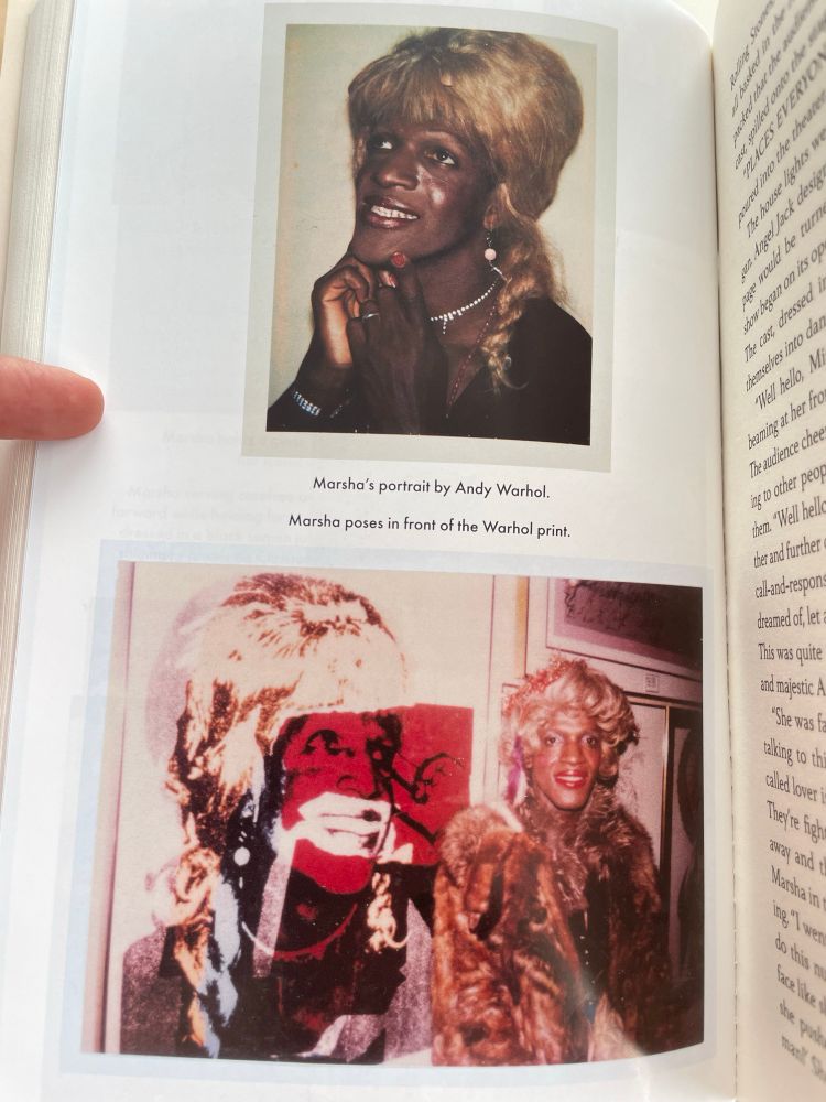Two photos of Marsha: on top a portrait by Andy Warhol and bottom a photo of Marsha posing next to a full size print of the photo, she’s wearing a fur coat, red lipstick, and a blonde wig.