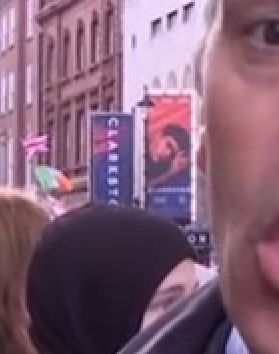 Closer view of the Clarkston poster featuring Joe Locke outside the Trafalgar Theatre behind Daniel Sandford on BBC News.