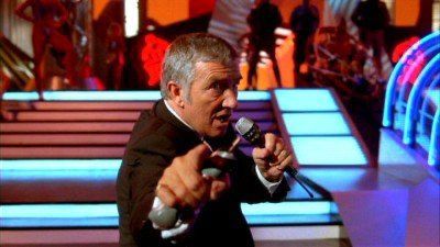 Richard Dawson as the evil host of The Running Man game show 