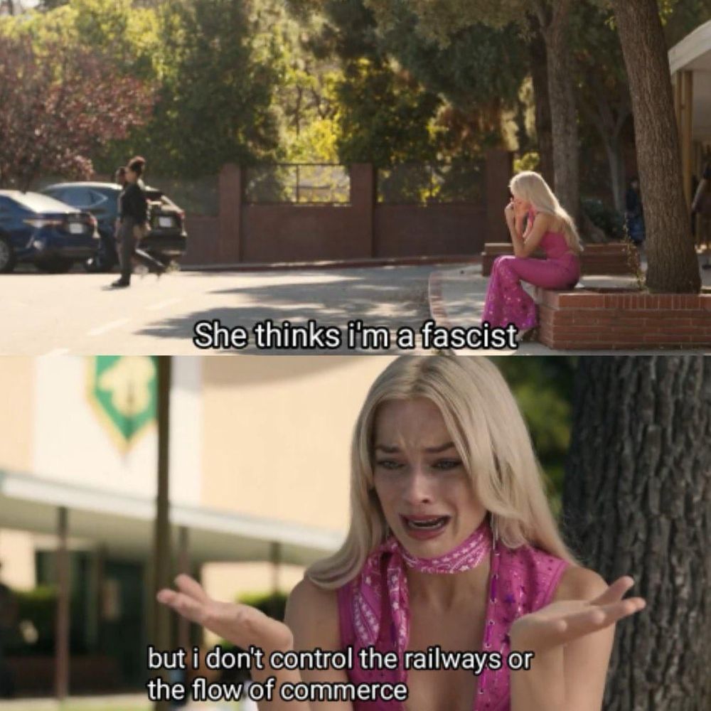 Barbie sitting on a curb, bemoaning the fact that a young girl just insulted her by calling her a fascist. Barbie laments “she thinks I’m a fascist, but I don’t control the railways or the flow of commerce”
