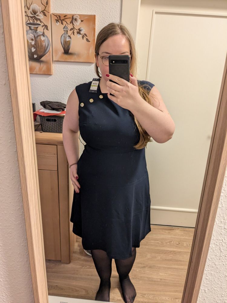 Spiegel selfie ich trage einen mittellanges dunkelblaues Kleid. Es ist tailliert, bis zu den Knien lang und oberarmfrei dort zu sehen. Meine Figur