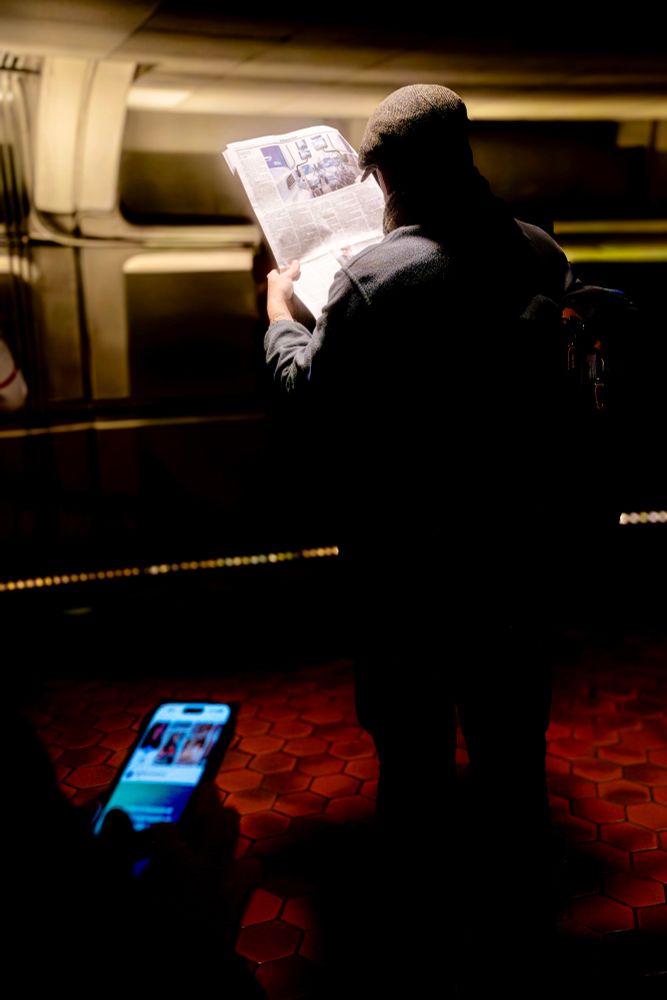 A man in a Metro station reads a newspaper set to the song “The Daily Mail” by Radiohead. 