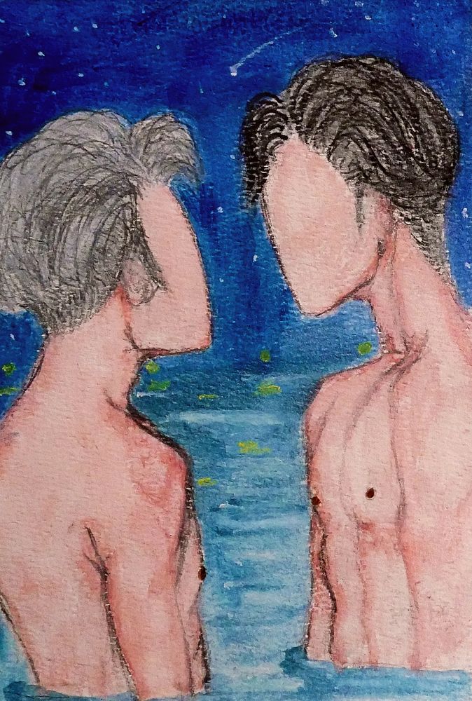 two men bathing in the ocean at night