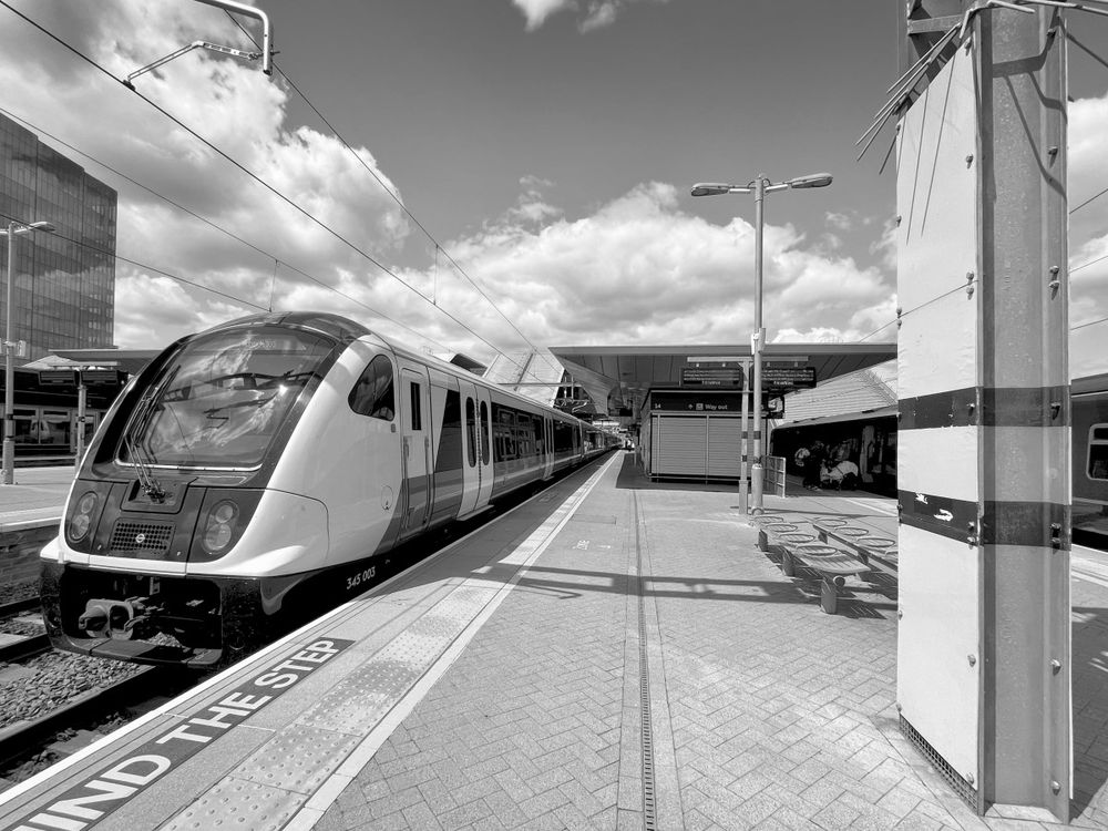 A black and white photograph of an Elizabeth Line train at Reading station. Taken using my iPhone and edited in DXO Photolab and Nik Silver Efex.