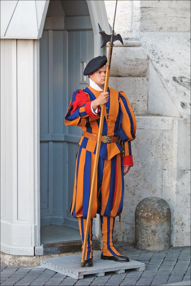 Papal Swiss Guard in traditional poofy costume, wielding a traditional halberd
