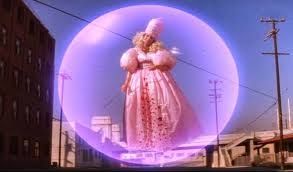 Woman in pink costume floating inside a bubble. Sheryl Lee as the Good Fairy in the film Wild at Heart