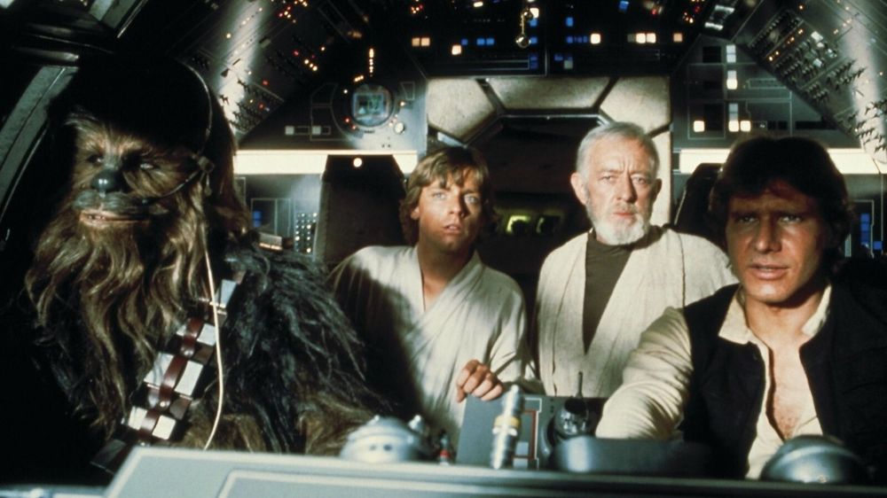 Chewbacca, Luke Skywalker, Obi Wan Kenobi and Han Solo in the cockpit of the Millennium Falcon