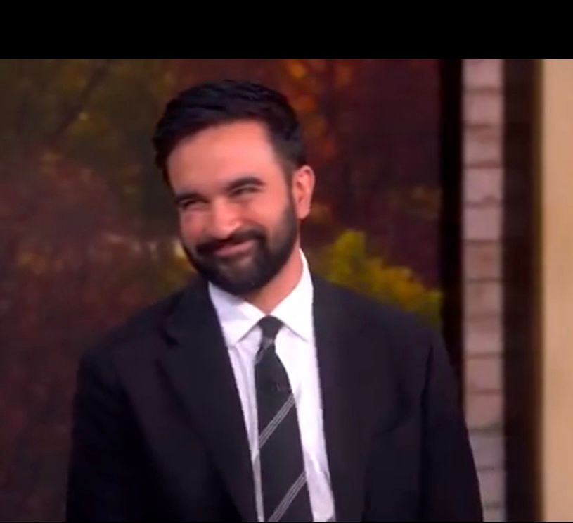 Zohran Mamdani smiling at a host on the view after asking asinine questions.  