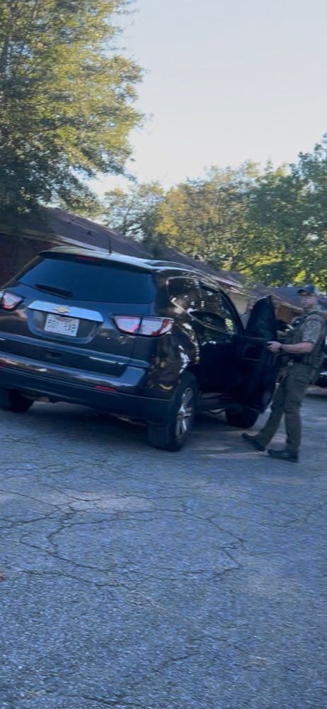 Law enforcement officer  off of 12 st in a residential neighborhood in Little Rock, Arkansas possibly ICE looking in someone’s back seat. 