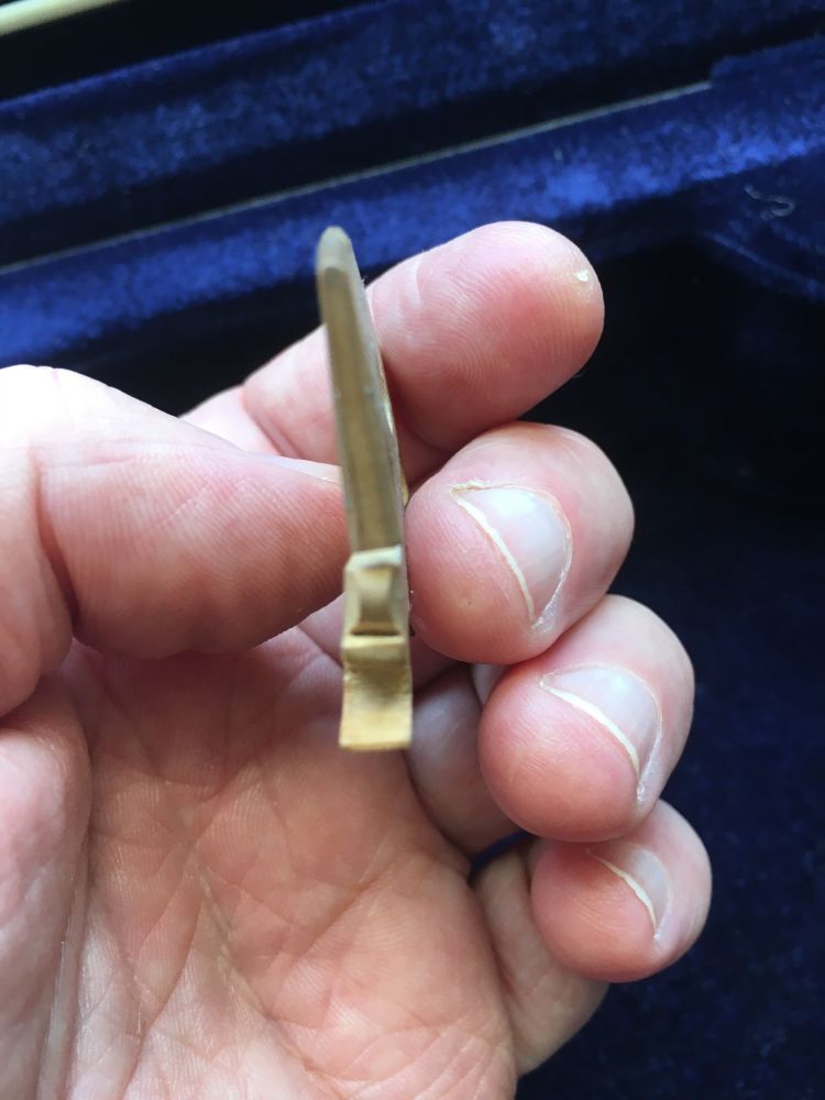 Violin warped bridge replacement.

Image shows the degree of warp on the old bridge.