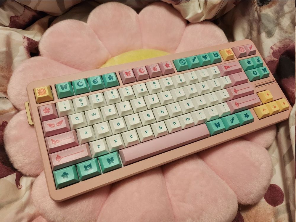 A desk with a computer keyboard (Wooting 80HE in a pink GT-80 case with DSA Magic Girl keycaps) beside a computer mouse (G-Wolves HSK 4k pro mouse) on a mousepad (Wallhack SP-004 frenzy sora).