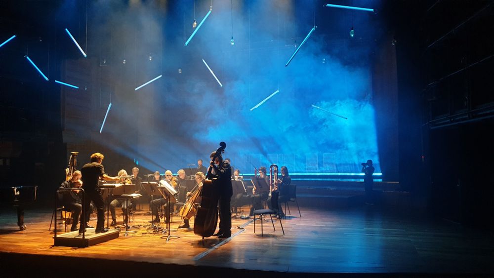 London Sinfonietta on stage at QEH with blue light and smoke behind