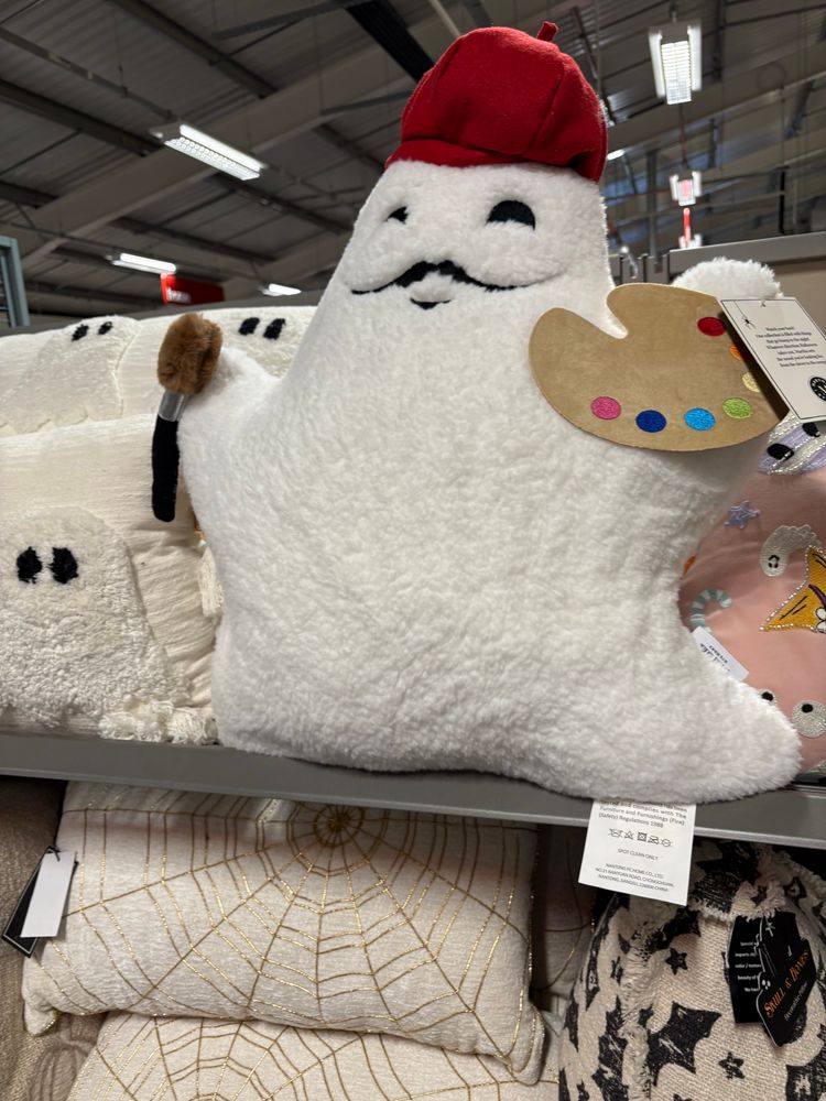 Pillow in the style of a ghost, who is a painter wearing a red beret 