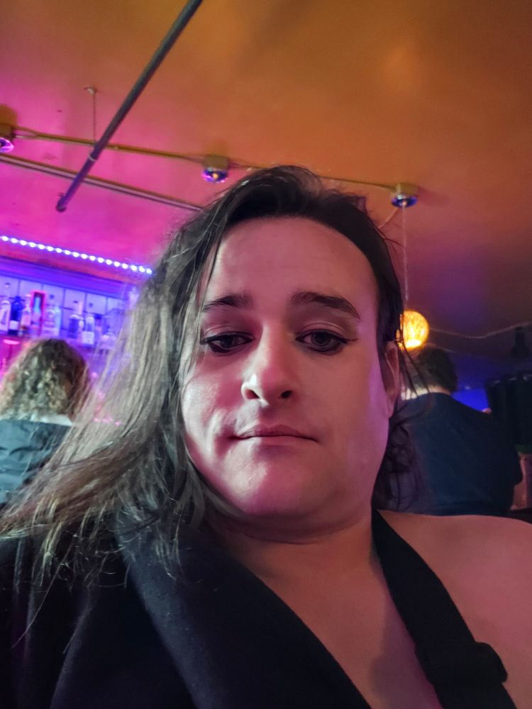 Mckitty sitting in a bar LED bicolors behind her