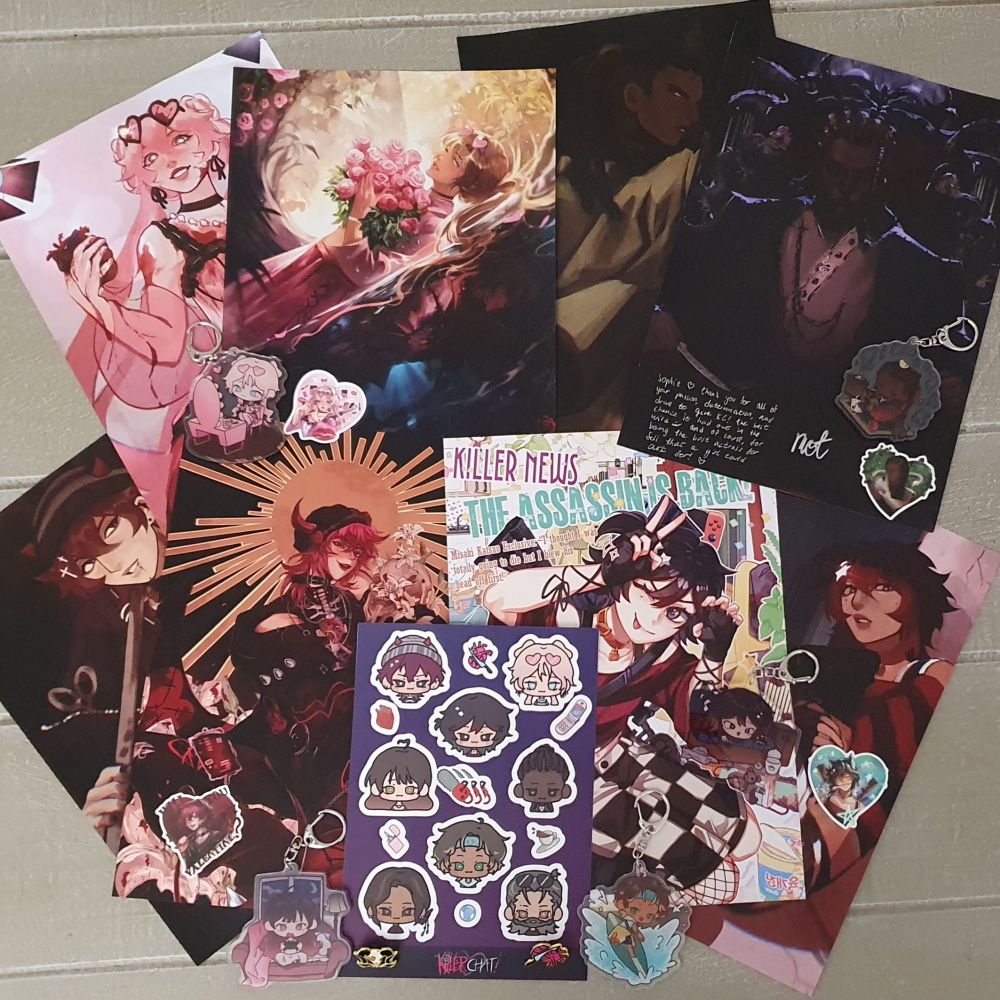 A selection of Killer Chat merch laid out (posters, stickers, keychains, pins)