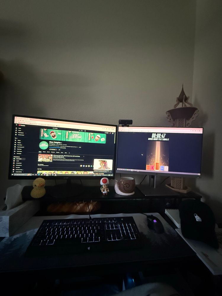 Desk with two monitors. One with the new heights YouTube channel and the other with Taylor Swifts website countdown