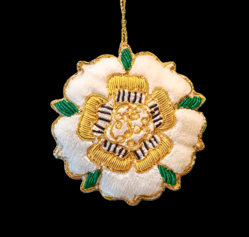 Cloth 3-D white rose with green embroidered leaves and gold highlights throughout.