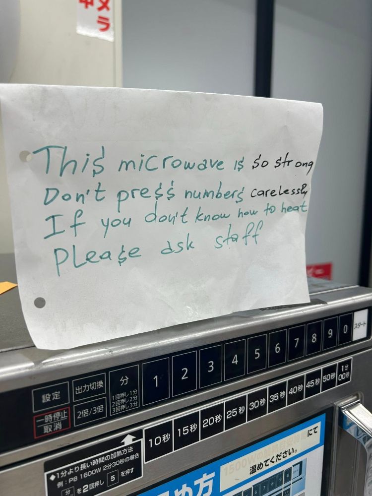 Sign on a microwave in Tokyo reading "This microwave is so strong. Don't press numbers carelessly if you don't know how to heat. Please ask staff."