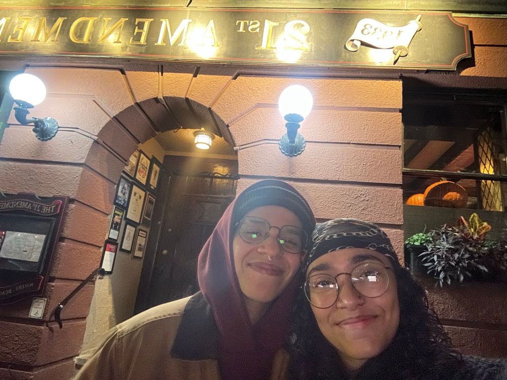 a selfie of myself and my wife in front of the 21st Amendment bar in Boston. 