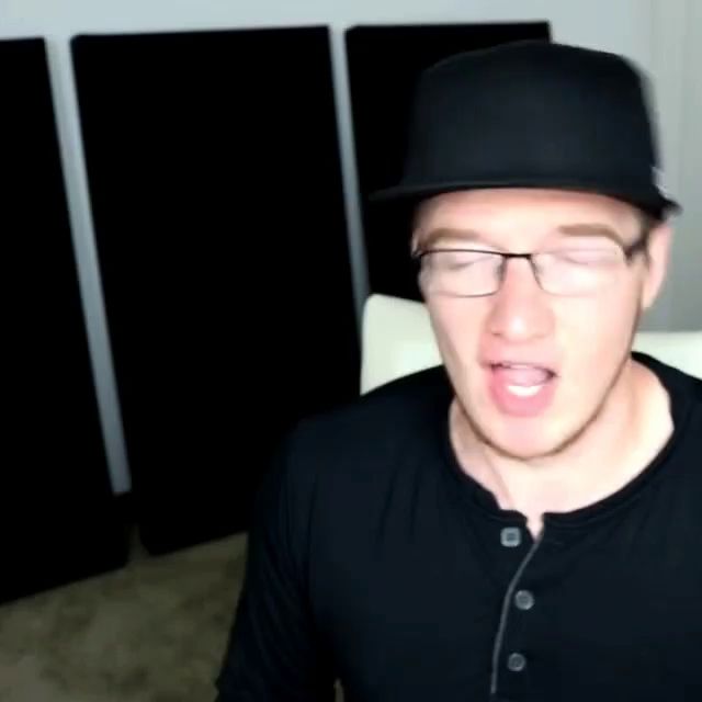 a man wearing glasses and a hat is making a face