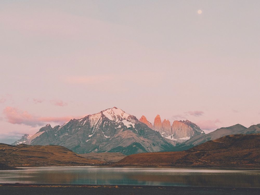 sunrise on Torres del Paine, the mountains are cast in a pink glow