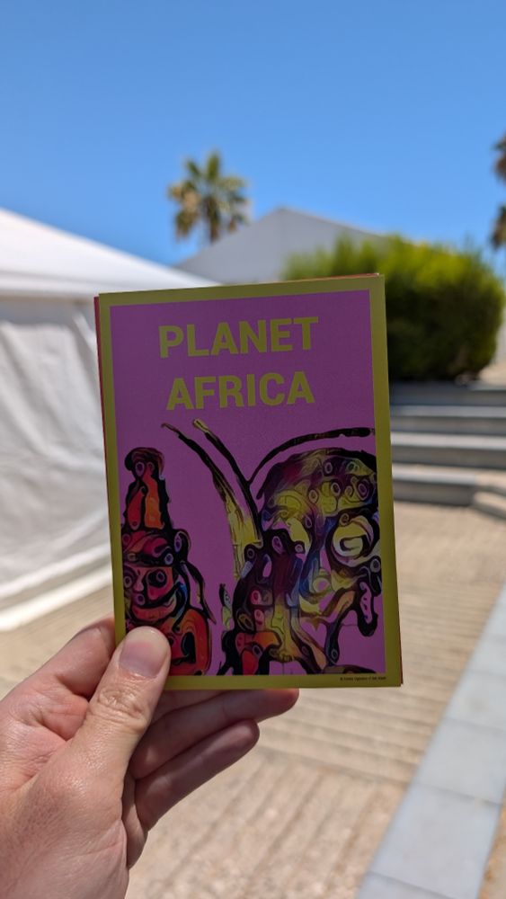 Pink postcard of Planet Africa Exhibition.