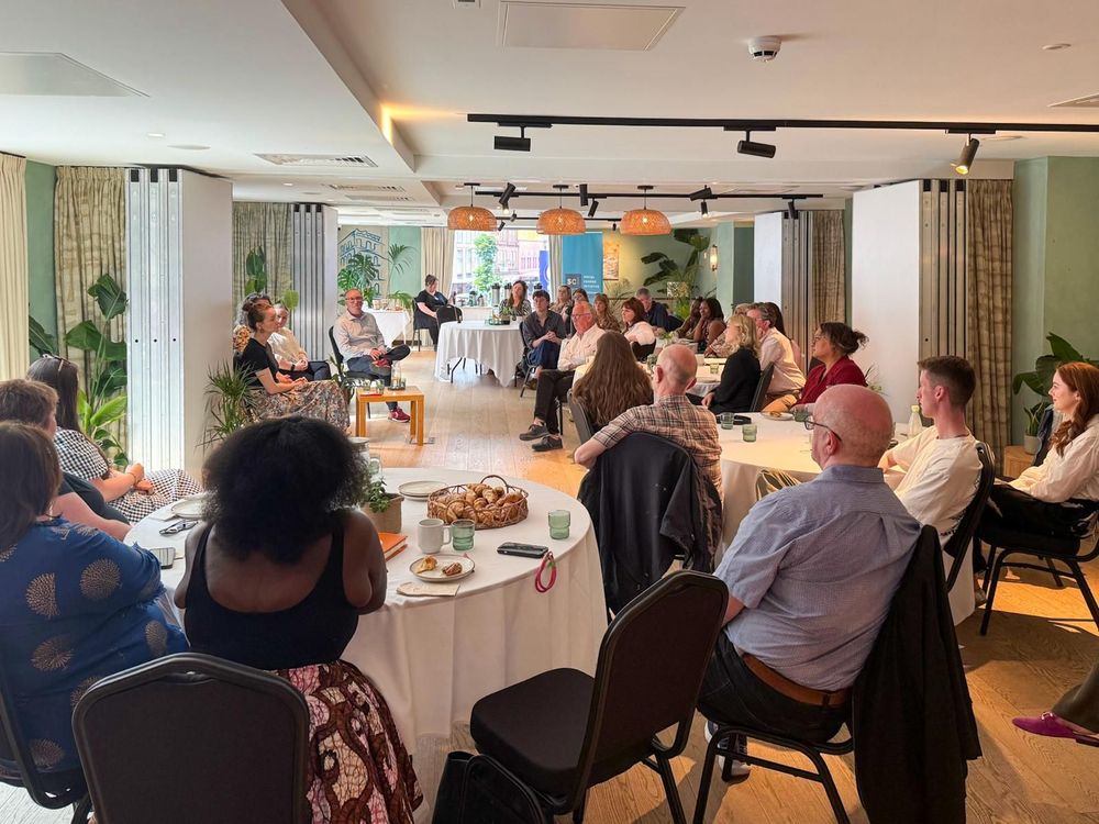 Image show all participants in the room watching a panel with Teresa Buczkowska, Kate Barry and Shauna Corr.