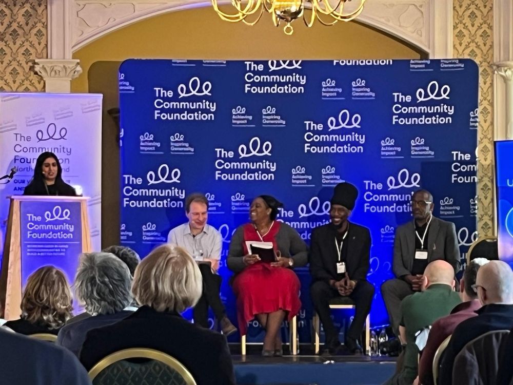 Photo by NICVA - Dr. Nazia Latif speaking from a podium at the conference.