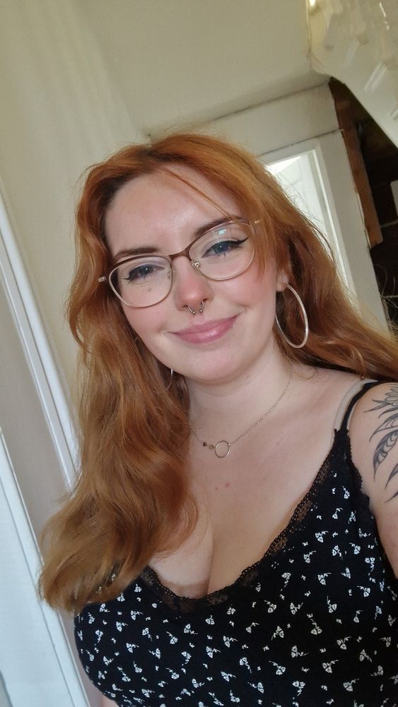 Ginger woman in black top
