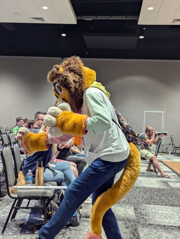 Lion fursuiter getting funky with it
