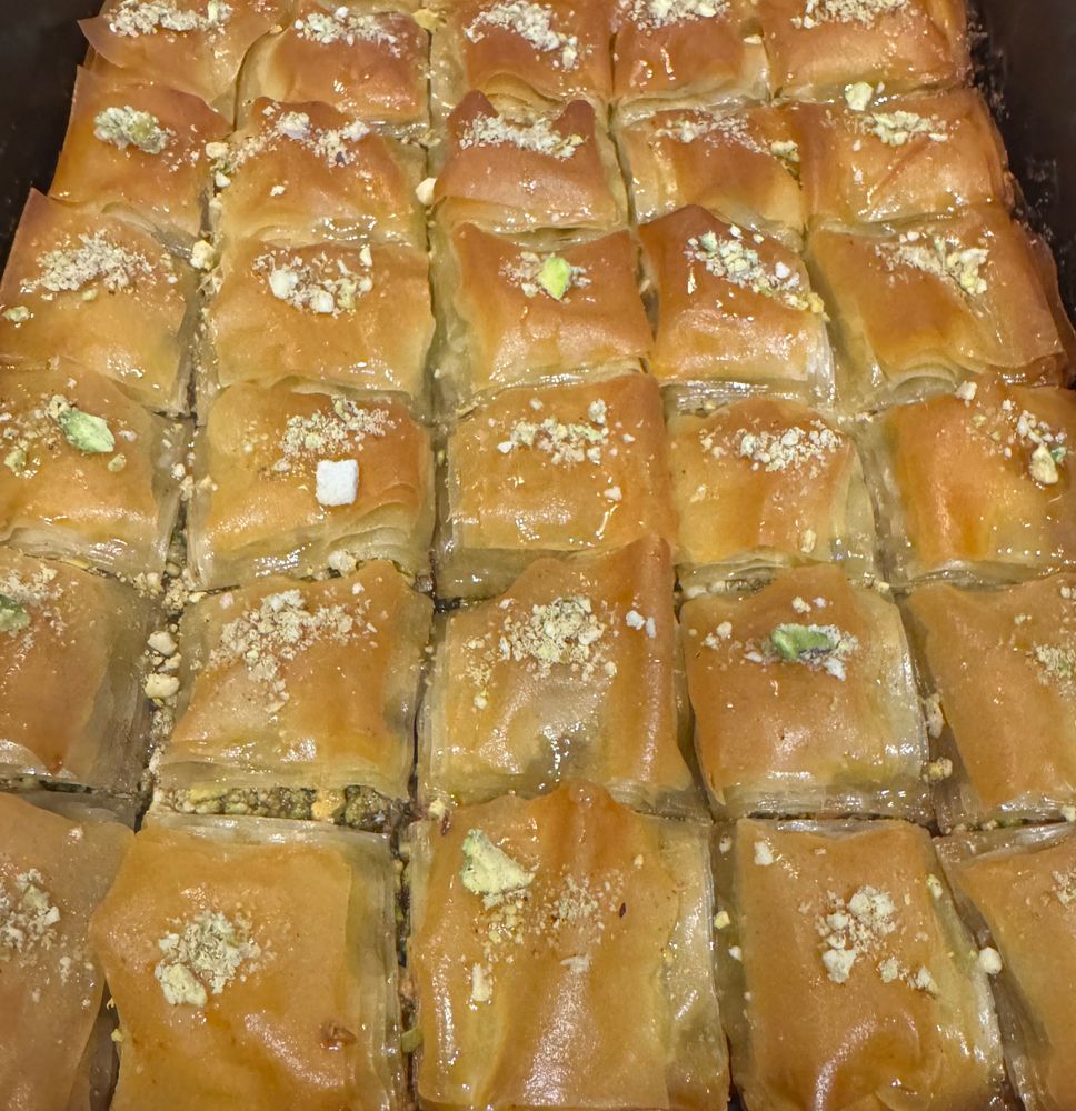 A tray of very neatly scored square cashew and pistachio baklava 