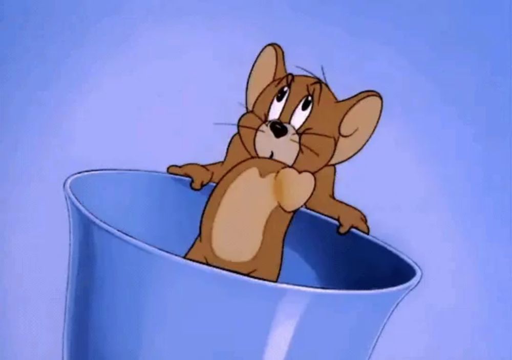 a cartoon mouse is sitting in a blue bowl