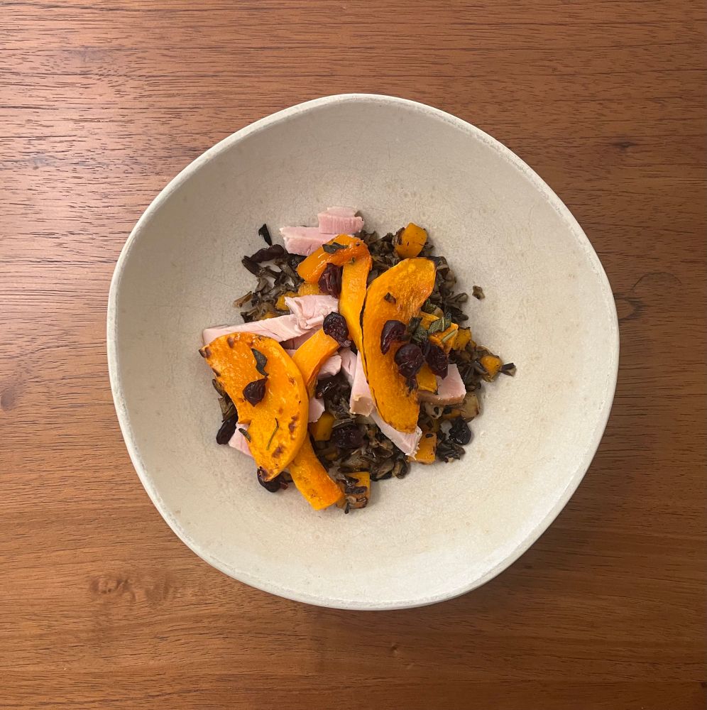 A fried wild rice bowl with turnip, butternut squash, leeks, and smoked turkey.