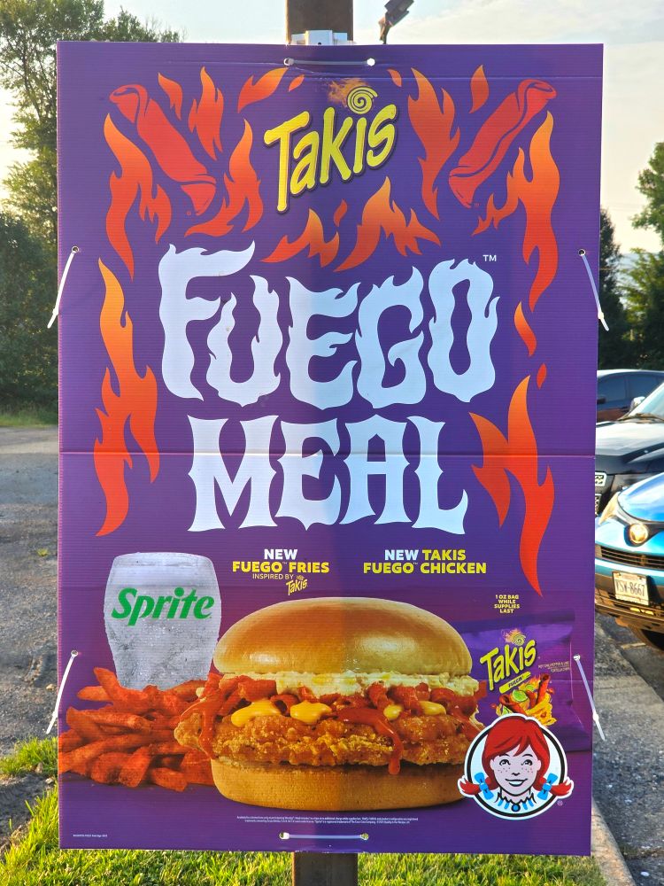 A Wendy's restraunt with a re-hung sign using pole mount hardware.