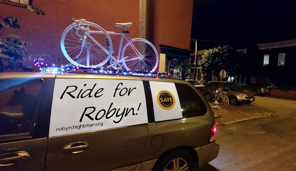 Photo of two ghost bikes in memory of Robyn Hightman. The photo was taken at Robyn's ghost bike in the Church Hill District of Richmond, Virginia.