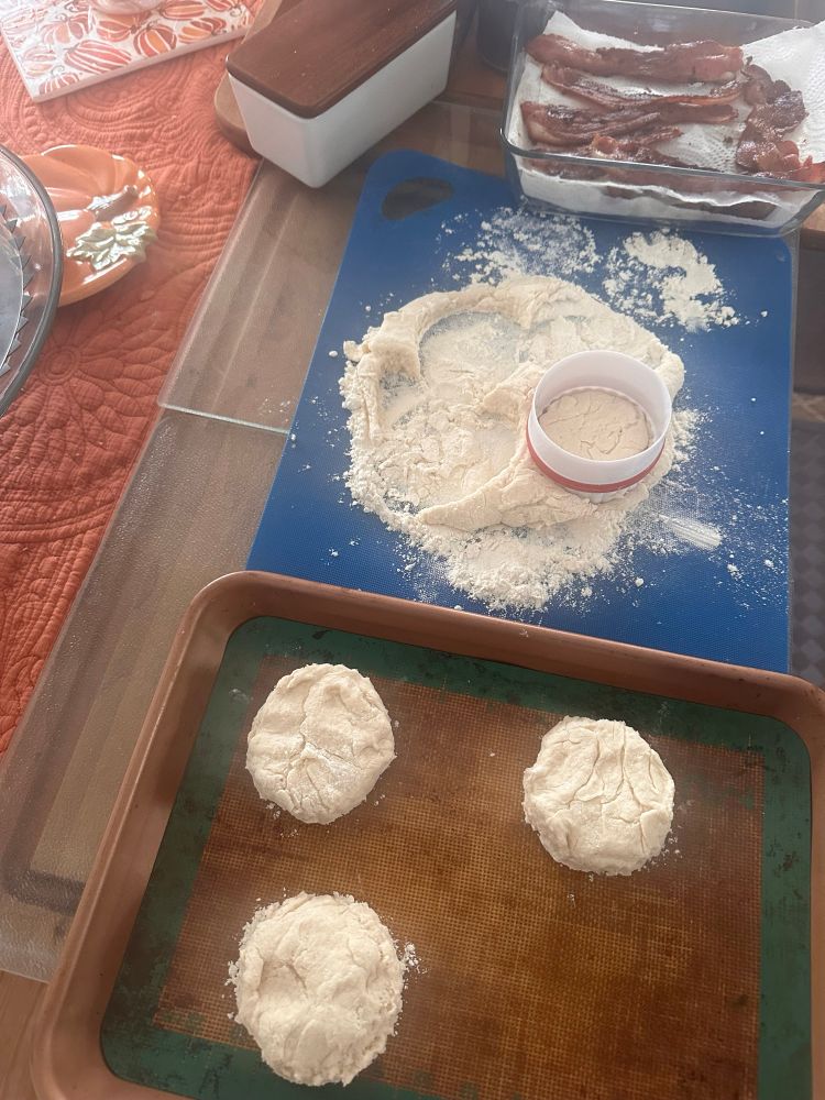 Biscuit dough being cut out & placed on baking mat