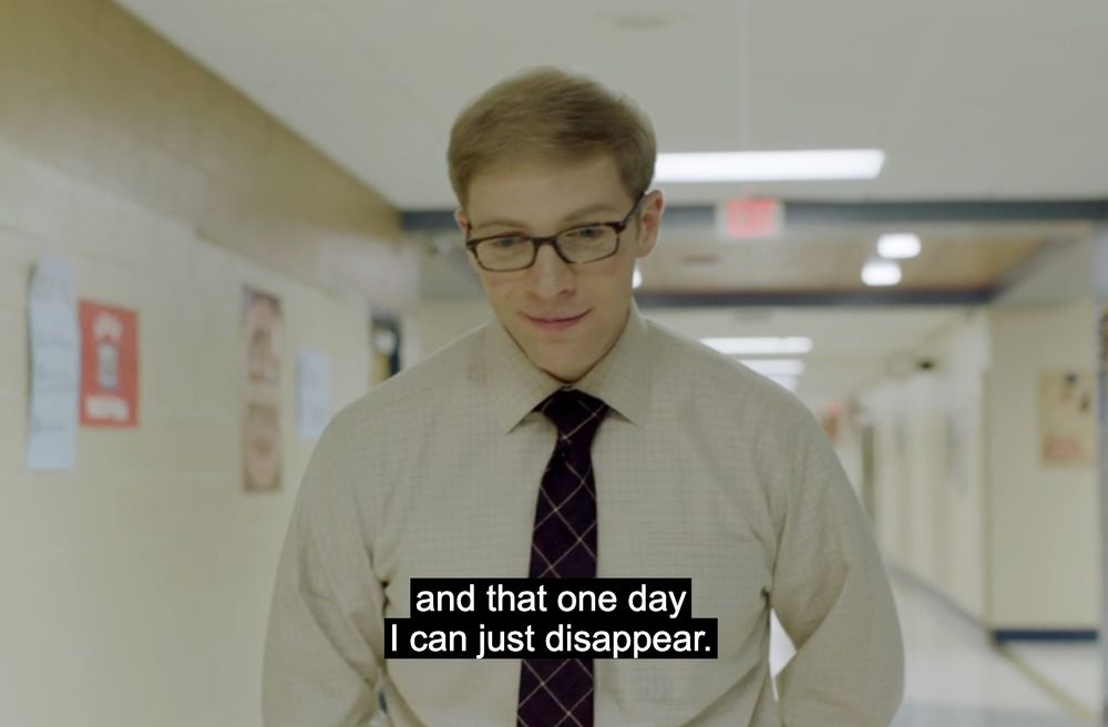 Screenshot of the show Joe Pera talks to you. Joe Pera is standing in a hallway, the screenshot reads "and that one day i can just disappear"