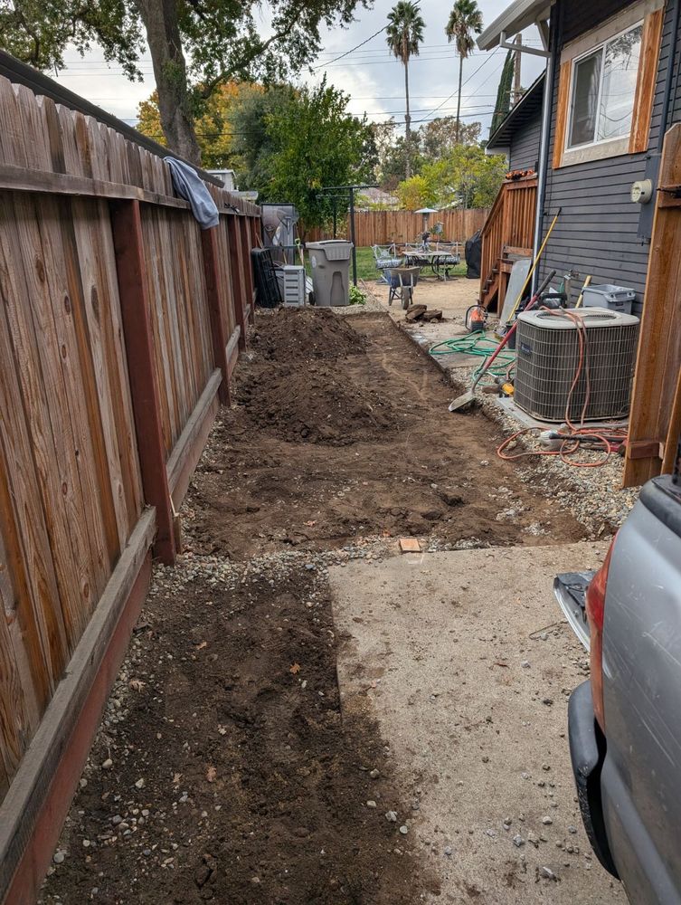 Torn up concrete on the side of a house. 