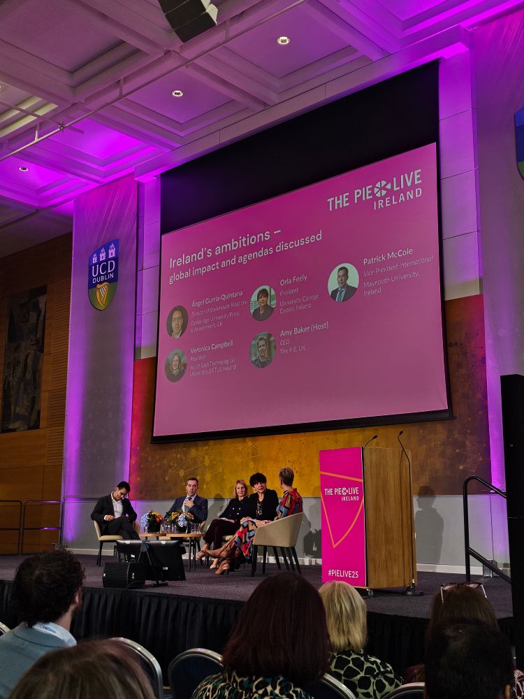 Five people on stage in panel set up
